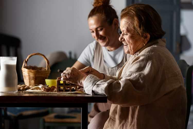An NDIS support worker and participant doing crafts together